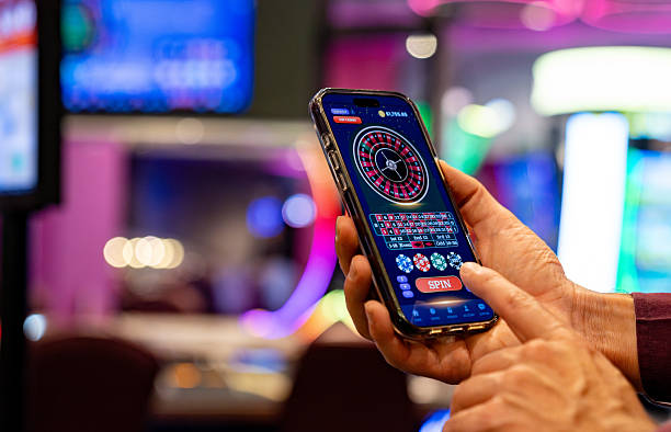 Mobile phone showing Wild Coaster betting interface with stake input and active table